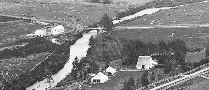 Homedale c1880s - McIlvride property to the left and Wainuiomata School to the right. Moores Valley Road in the foreground with what could be boxing for road widening.