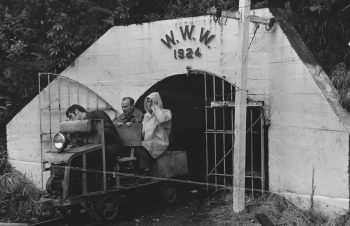 L3752 Orongorongo River end of tunnel (water intake inspection by County Town Committee) Reg. Moore & Bill McCabe (in raincoat) as passengers - 1970s - WHMS: L3752