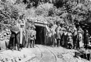 Group in Wainuiomata at the opening of a tunnel housing the Wainuiomata-Orongorongo water pipe. Mack, R M (Mr), fl 1983 :Photographs. Ref: 1/2-140140-F. Alexander Turnbull Library, Wellington, New Zealand. /records/22686333