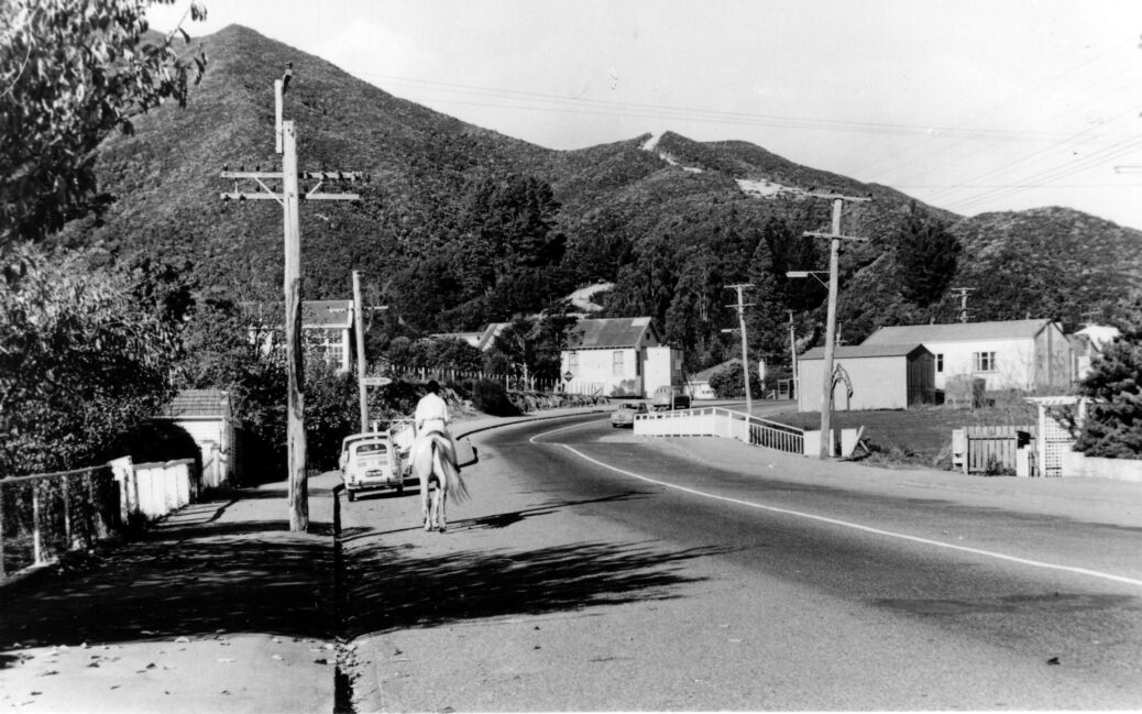 Main Road in 1970 with old school building (left), old Public Hall (centre), fire engine garage & Riverside Hall (right) - WHMS: L3034