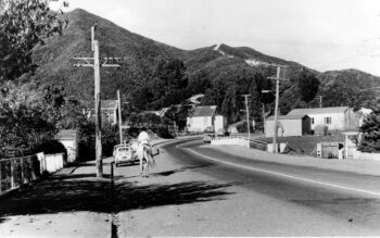 Main Road in 1970 with old school building (left), old Public Hall (centre), fire engine garage & Riverside Hall (right) - WHMS: L3034