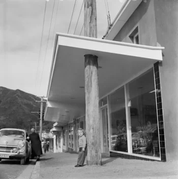 4 August 1959 Shop verandah built around a wooden telegraph pole, Wainuiomata. Evening post (Newspaper. 1865-2002) :Photographic negatives and prints of the Evening Post newspaper. Ref: EP/1959/2700-F. Alexander Turnbull Library, Wellington, New Zealand. https://natlib.govt.nz/records/23131624