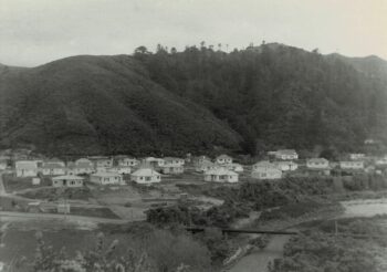 Hine Road Wainuiomata in the 1960s with water pipes visible - Source: Wainuiomata Historical Museum Society