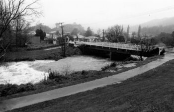 Flooded Wainuiomata River & Main Road Bridge - 28 July 1985 - © Wainuiomata Historical Museum