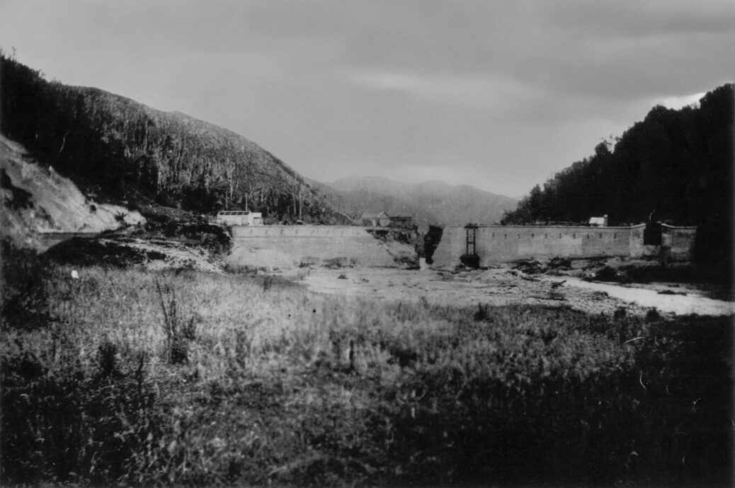 Wainuiomata Dam Damage and Dam Worker Huts in 1884 -Source: Wainuiomata Historic Museum Society (L3591).